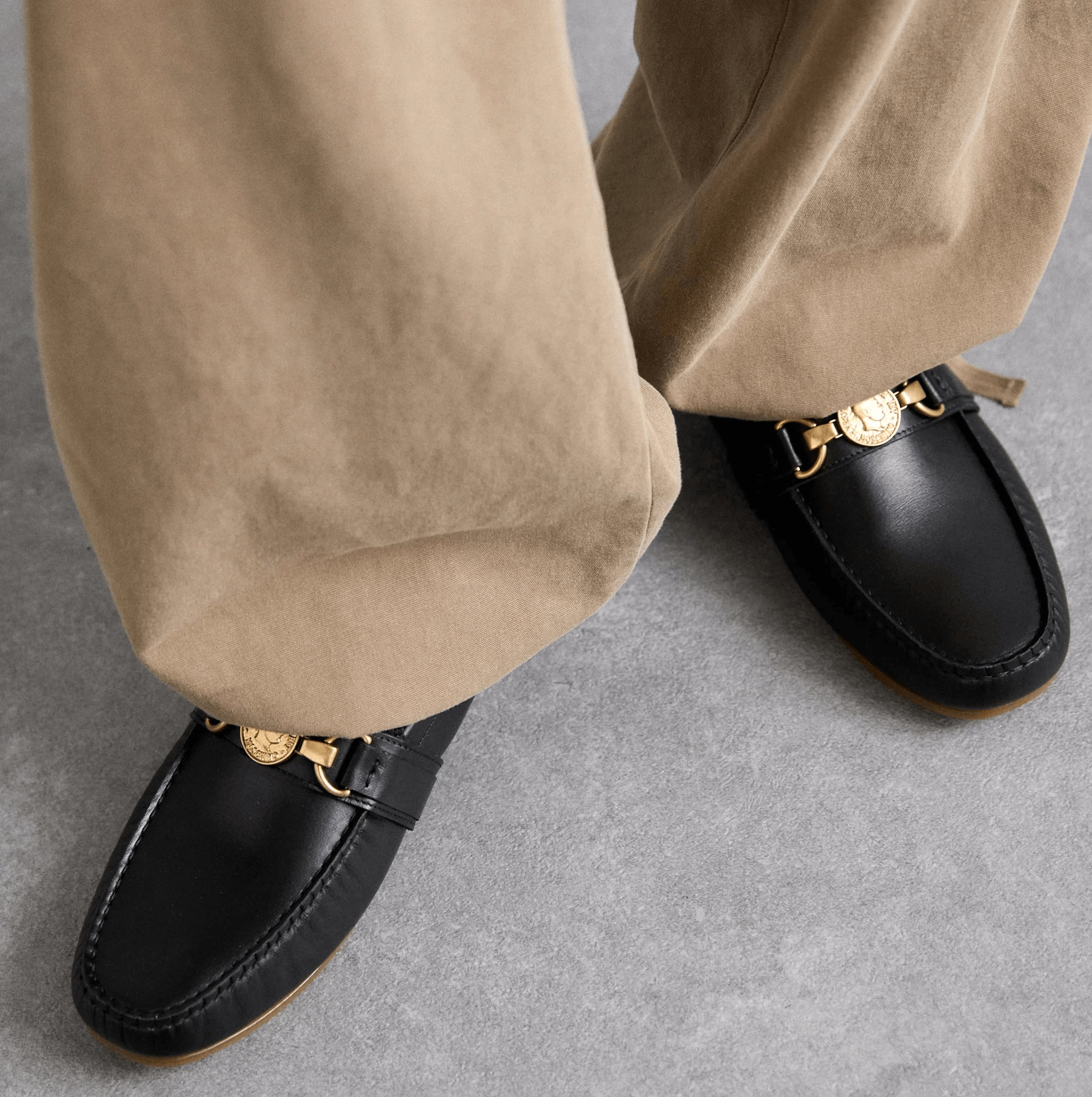 Moschino mocassini pelle 210Z3L04D100 in pelle nera, indossati con pantaloni beige