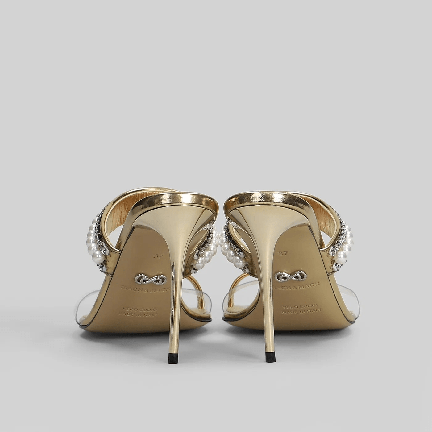 Sandali mule oro cristalli perline tacco 9,5 cm con strap trasparente e dettagli in perline e cristalli.