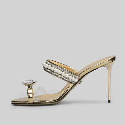 Sandali mule oro cristalli perline tacco 9,5 cm con strap trasparente e dettagli in perline e cristalli.